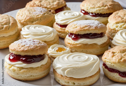 Top-down view of scones with jam and buttercream