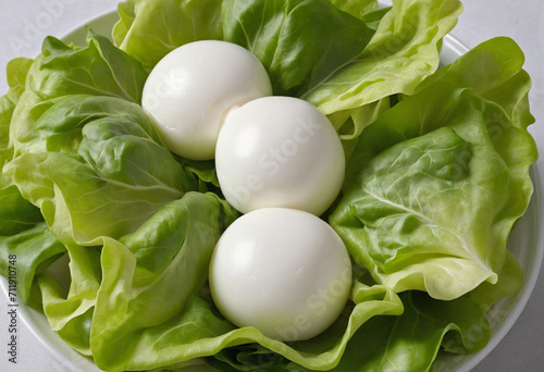 Close-up of mozzarella balls and lettuce leaves