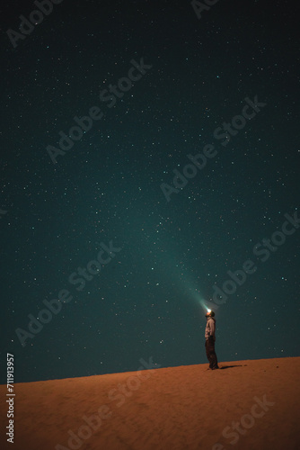 The starry night sky in Morroco with a traveler.