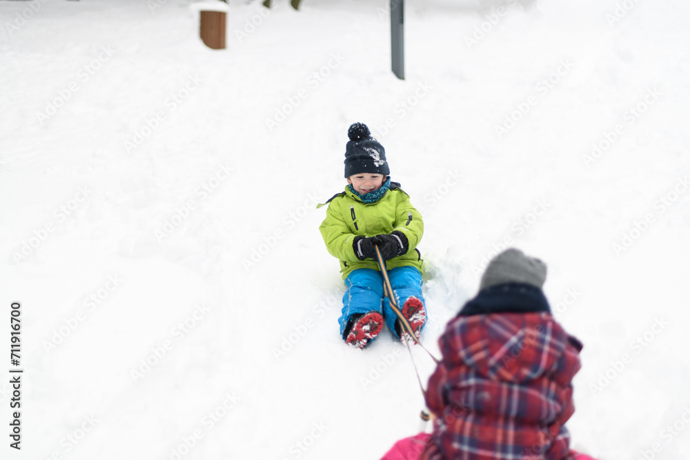 Kids Having Fun on Sledding Playing in Snow