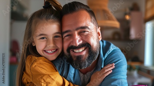 portrait of caring father embracing happy girl photo