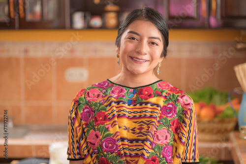 Portrait of an indigenous woman looking at camera smiling and happy.