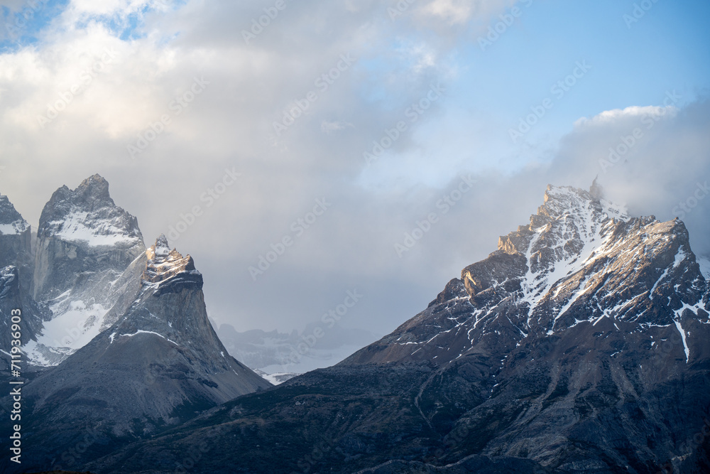 snow covered mountains under clouds and sunlight snow covered mountains under clouds and sunlight