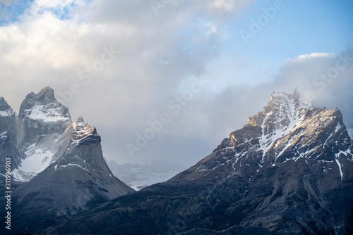 snow covered mountains under clouds and sunlight © Yan