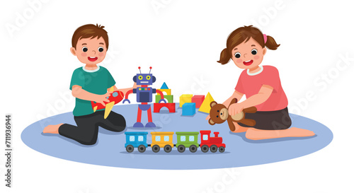 Cute little kids playing toys sitting on the floor together