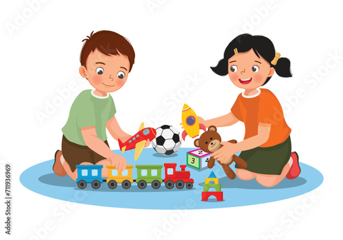 Happy little children playing toys sitting on the floor together