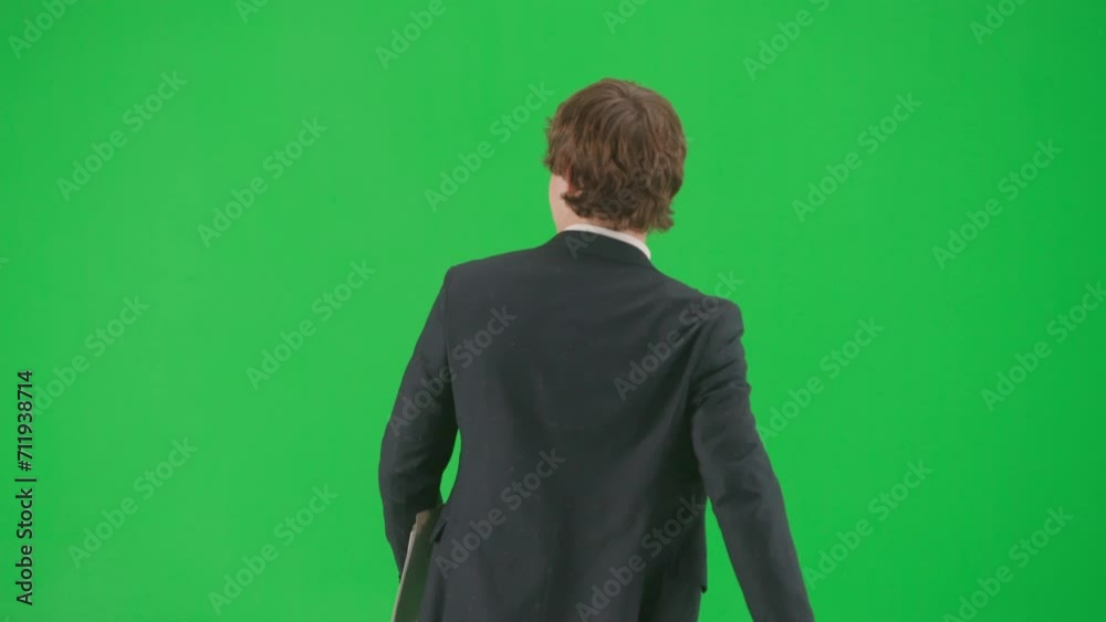 Portrait of male model in suit on chroma key green screen background . Handsome young businessman in trendy suit walking waving hand greeting people Portrait of male model in suit on chroma key green screen background . Handsome young businessman in trendy suit walking waving hand greeting people