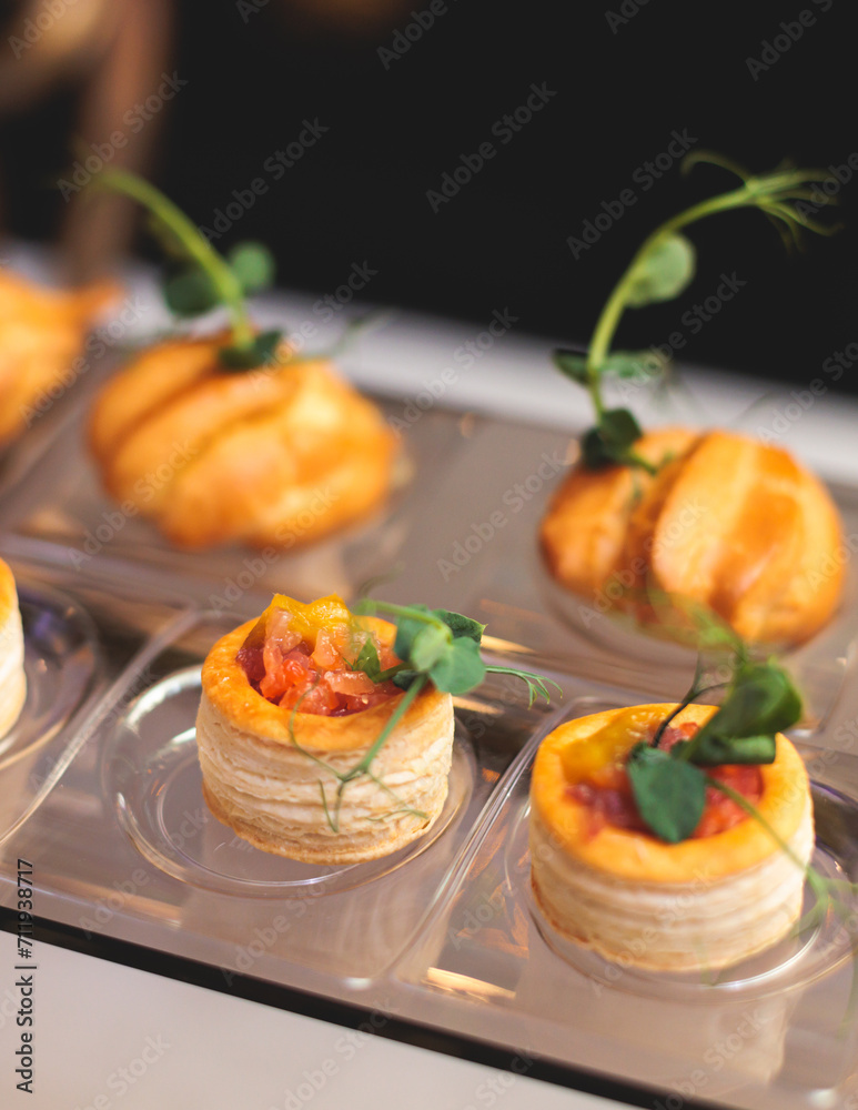 Beautifully decorated banquet catering table, with variety of with different food snacks appetizers on corporate birthday party event or wedding celebration, canape, salad, delicatessen setting Beautifully decorated banquet catering table, with variety of with different food snacks appetizers on corporate birthday party event or wedding celebration, canape, salad, delicatessen setting