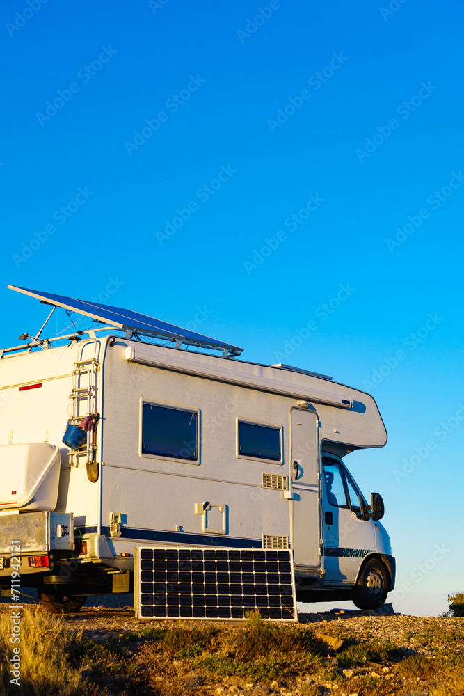 Caravan with tilt solar panels on roof.