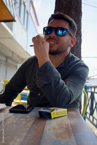 latino man smoking in a coffee shop