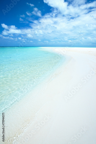 Sandy beach and turquoise sea in the Maldives photo