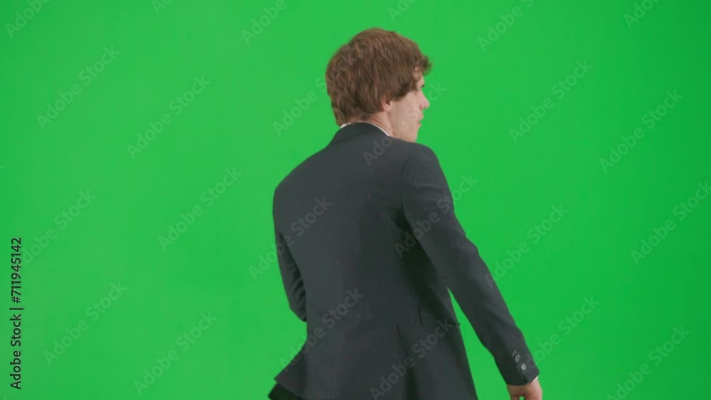 Portrait of male model in suit on chroma key green screen background. Stylish young businessman in trendy suit walking and dancing. Portrait of male model in suit on chroma key green screen background. Stylish young businessman in trendy suit walking and dancing.