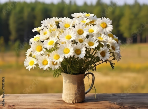 Daisies of Romance: A Colorful Floral Arrangement on a Wooden Table in a Sunlit Meadow