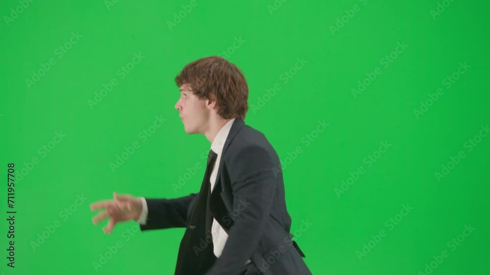 Portrait of male model in suit on chroma key green screen. Handsome young businessman in trendy suit dancing funny disco dance. Portrait of male model in suit on chroma key green screen. Handsome young businessman in trendy suit dancing funny disco dance.