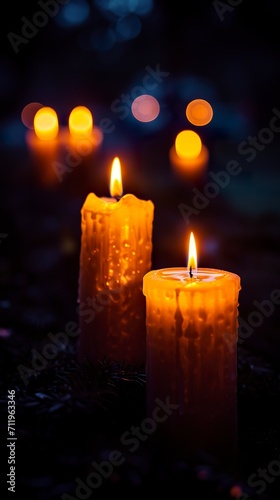 Several candles lit under a night vigil in a dark environment. Glow of candle flames in solemn and magical atmosphere. Concept of remembrance and hope.