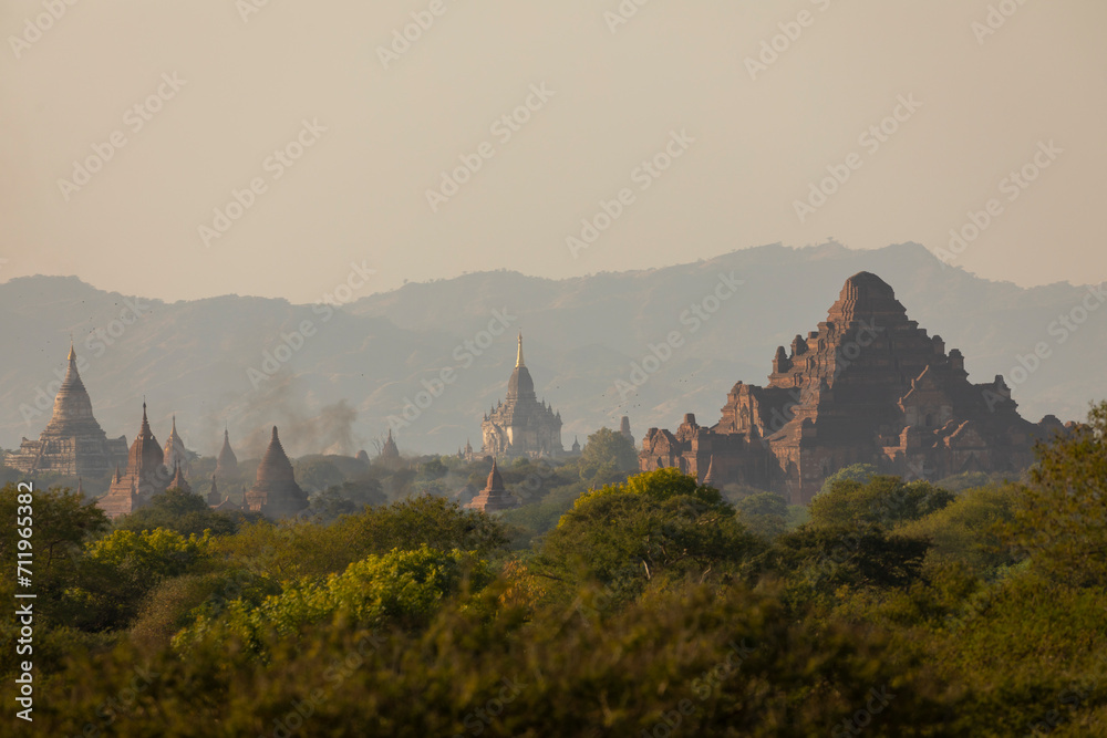 A landscape of mountains, temples and pagodas, immersed in the haze, dust and dry forest that surrounds them, in Bagan, Myanmar
