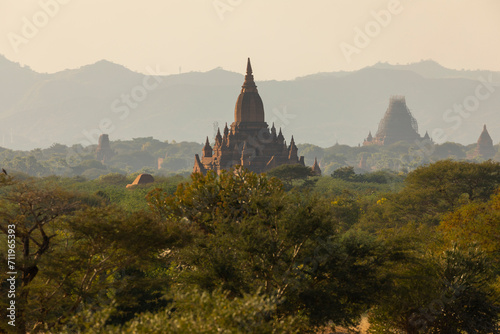 A landscape of mountains, temples and pagodas, immersed in the haze, dust and dry forest that surrounds them, in Bagan, Myanmar