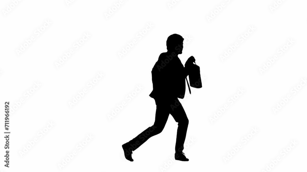 Modern businessman advertising concept. Man in studio isolated on white background with alpha channel. A black silhouette of a businessman in a suit dances joyfully with a suitcase in his hand. Modern businessman advertising concept. Man in studio isolated on white background with alpha channel. A black silhouette of a businessman in a suit dances joyfully with a suitcase in his hand.