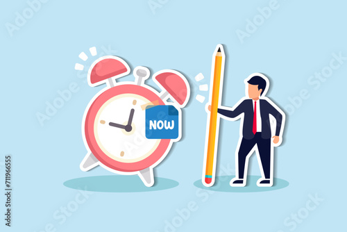 Stop procrastination, do it now or decision to finish work or appointment in time, punctuality concept, businessman with pencil after he wrote the word Now on note and stick it on ringing alarm clock. photo