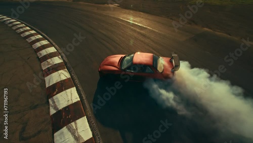 FPV drone shot of Race Car Drifting and making smoke on a track photo