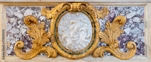 VICENZA, ITALY - NOVEMBER 5, 2023: The the marble baroqe relief of Virgin Mary among the saints on the side altar of church Chiesa di Santa Maria dei Servi by unknown artist. photo