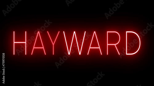 Flickering red retro style neon sign glowing against a black background for HAYWARD photo