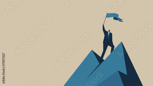 A man in a suit waves a flag on the top of a mountain.