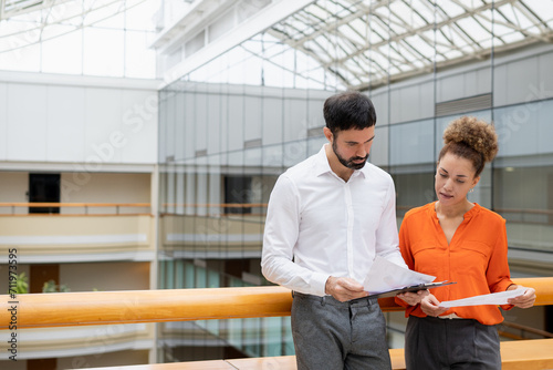 Businessman and lady in smart casual wear in the background business center
