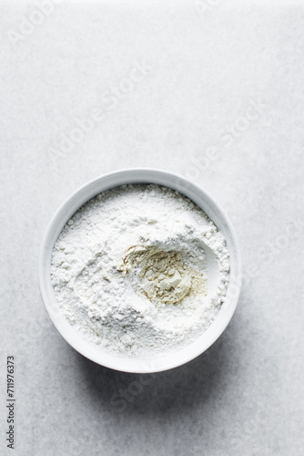 All purpose flour and vital wheat gluten in a ceramic bowl, process of making bread flour