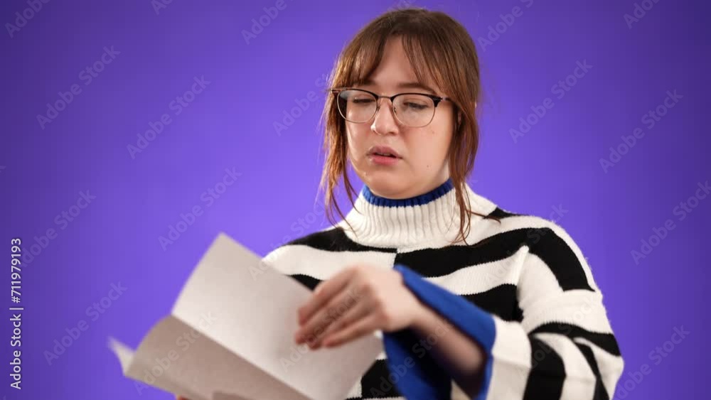 Angry stressed businesswoman opening envelope reading bad news in mail letter. Feels frustrated about high bills, dismissal notice, bank debt, tax invoice or mistake isolated on purple background