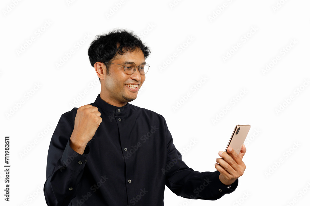 Excited happy young man winner feeling joy using smartphone winning lottery game, stock market,getting cashback online gift in mobile app message holding cell phone isolated on white background Excited happy young man winner feeling joy using smartphone winning lottery game, stock market,getting cashback online gift in mobile app message holding cell phone isolated on white background