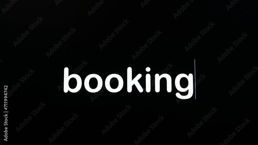 Writing on the screen with a flashing paragraph forming the word booking in white on a black background. Writing on the screen with a flashing paragraph forming the word booking in white on a black background.