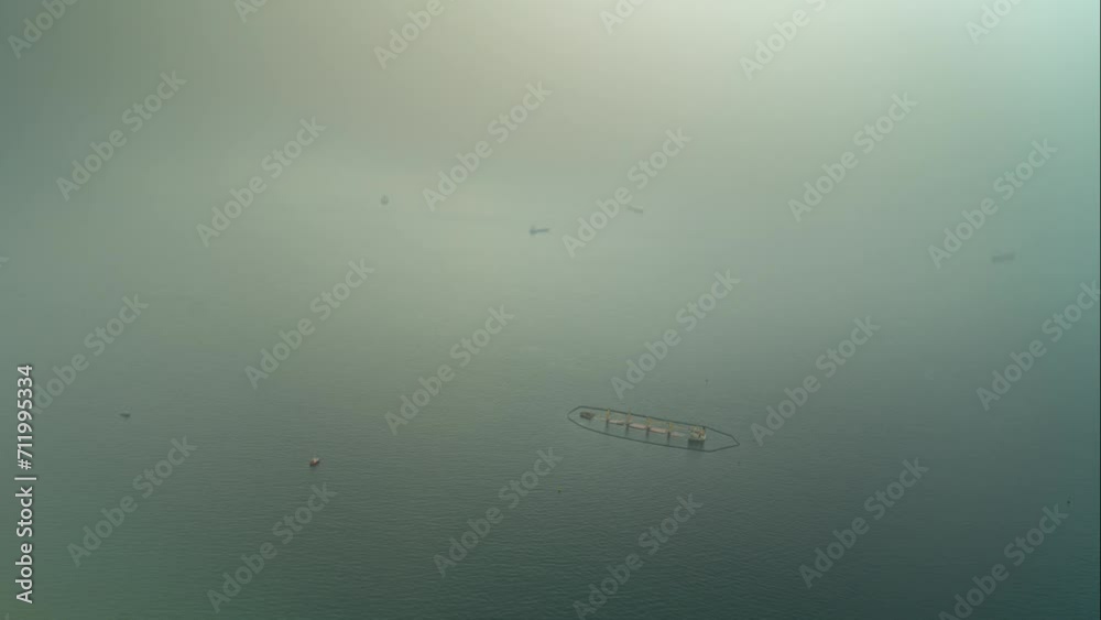 Floating farm and sailing vessel near Gibraltar, view from above Floating farm and sailing vessel near Gibraltar, view from above