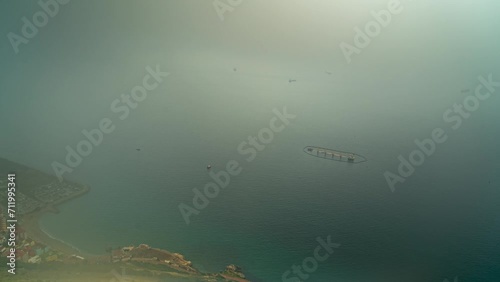 Floating farm and industrial port of Gibraltar coast, time lapse from above
