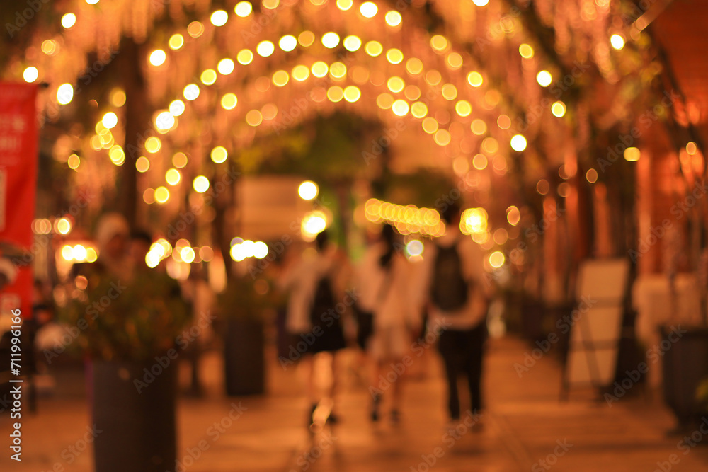 blur image of night festival in a restaurant and market street walk with bokeh for background