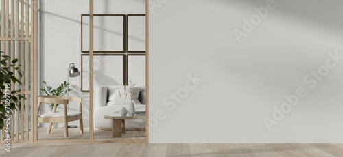 A modern, minimal white-furnished living room with an empty white wall and a parquet floor.