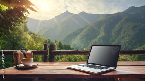 Workspace with laptop and coffee on wooden table with beautiful nature background. - digital nomad concept. photo
