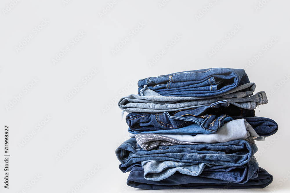 Stack of various shades of blue jeans on white background Stack of various shades of blue jeans on white background