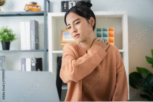 Asian business woman have a neck pain because using the computer and working for a long.