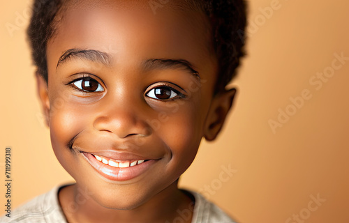 Portrait of a child black boy against a light brown background