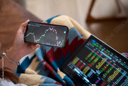 Woman is checking Bitcoin price chart on digital exchange on smartphone,