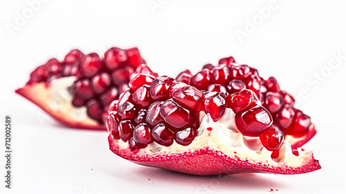 Ripe sweet pomegranate slices on a white background