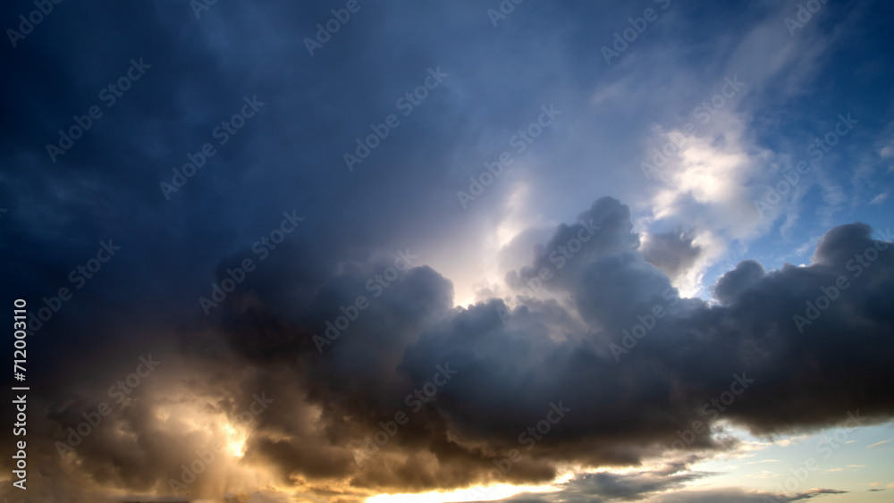 Stormy sky with dramatic clouds from an approaching thunderstorm at summer sunset