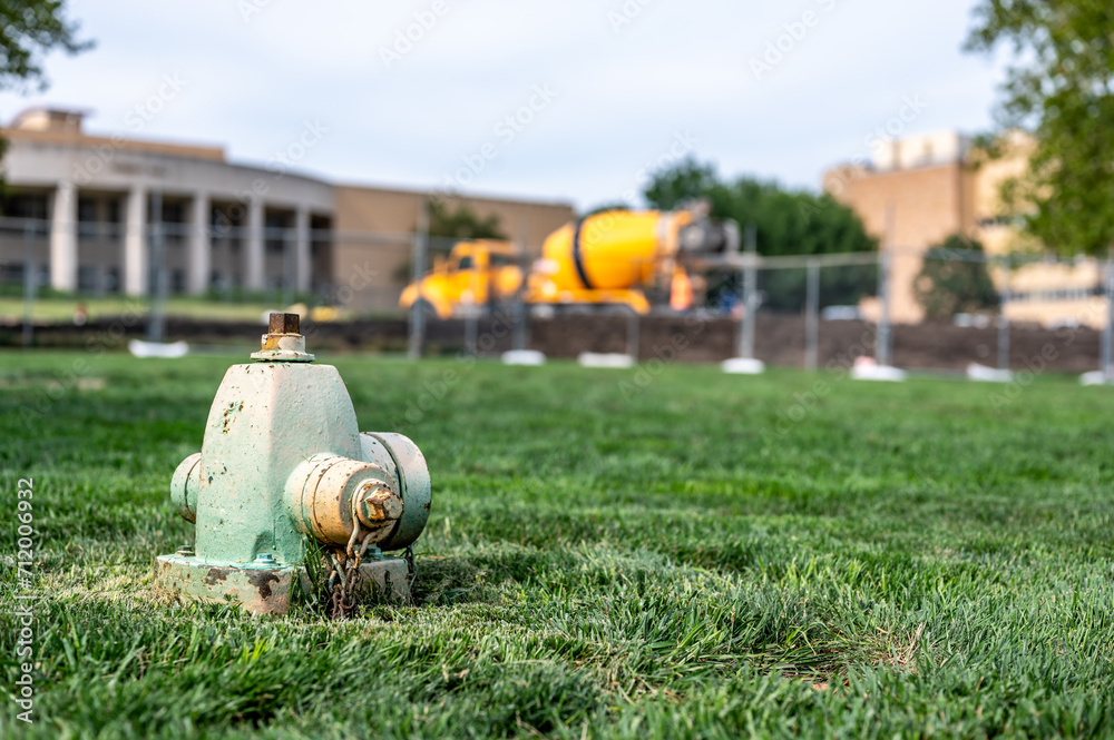 Fototapeta premium Sunken low level dry barrel fire hydrant in an open grassed area