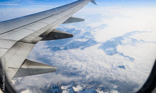 Obraz na płótnie Aerial view of high mountain peaks above clouds. Airplane flying towards Anchorage. Alaska. USA. w salonie