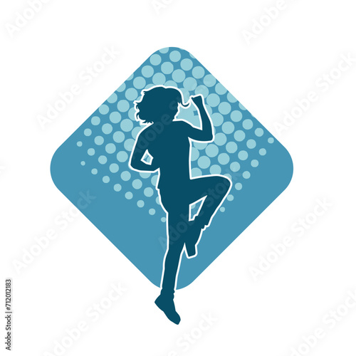 Silhouette of a female dancer in action pose. Silhouette of a woman dancing happily.