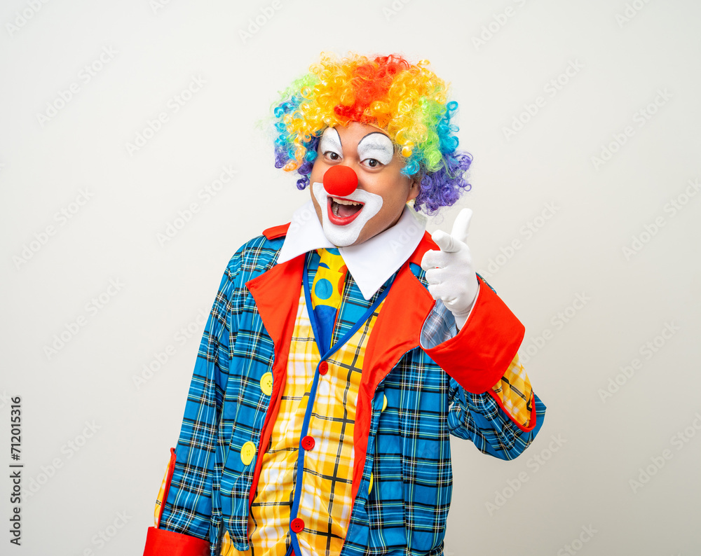 Mr Clown. Portrait of Funny comedian face Clown man in colorful uniform wearing wig standing pointing finger to camera. Happy expression amazed face male bozo in various pose on isolated background. Mr Clown. Portrait of Funny comedian face Clown man in colorful uniform wearing wig standing pointing finger to camera. Happy expression amazed face male bozo in various pose on isolated background.