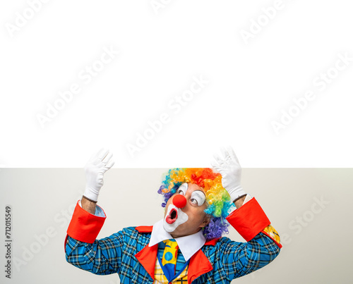 Mr Clown. Portrait of Funny face Clown man in colorful uniform standing holding copy space. Happy expression male bozo in various pose with frame mockup blank space on isolated background. photo