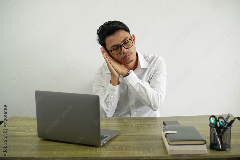 young asian businessman in a workplace making sleep gesture in dorable expression wear white shirt isolated young asian businessman in a workplace making sleep gesture in dorable expression wear white shirt isolated