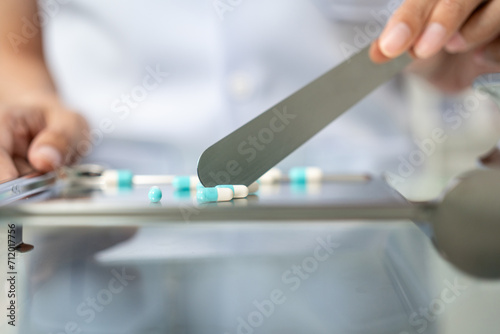 Close up Pharmacist woman hands counting drugs pills arranging assortment working in drug shelves counter checks inventory of medicine in pharmacy store. Professional Female Pharmacist with uniform